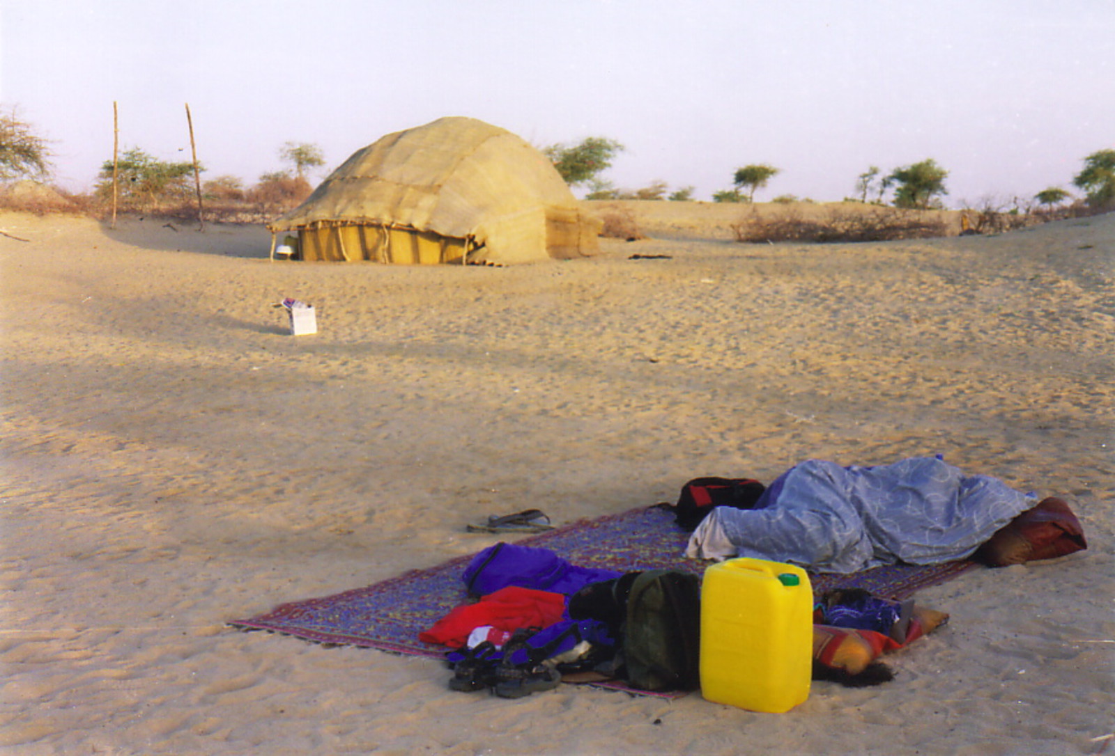 A camp on the sand by a Tuareg tent