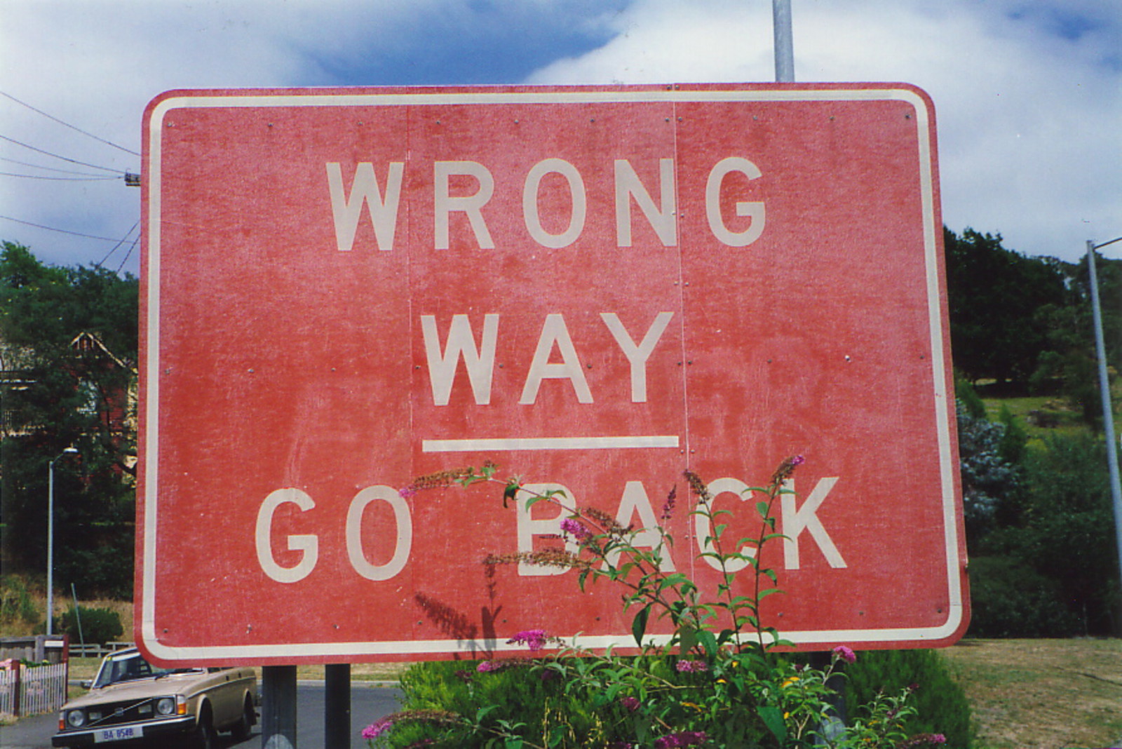 A road sign saying 'Wrong Way – Go Back'