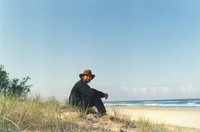 Mark sitting on a beach