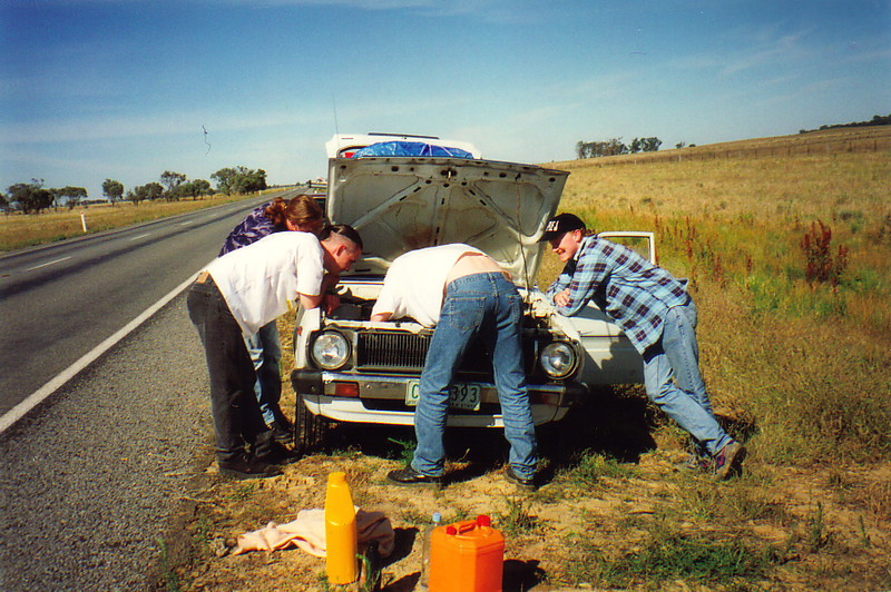 The boys peering under the bonnet of a car