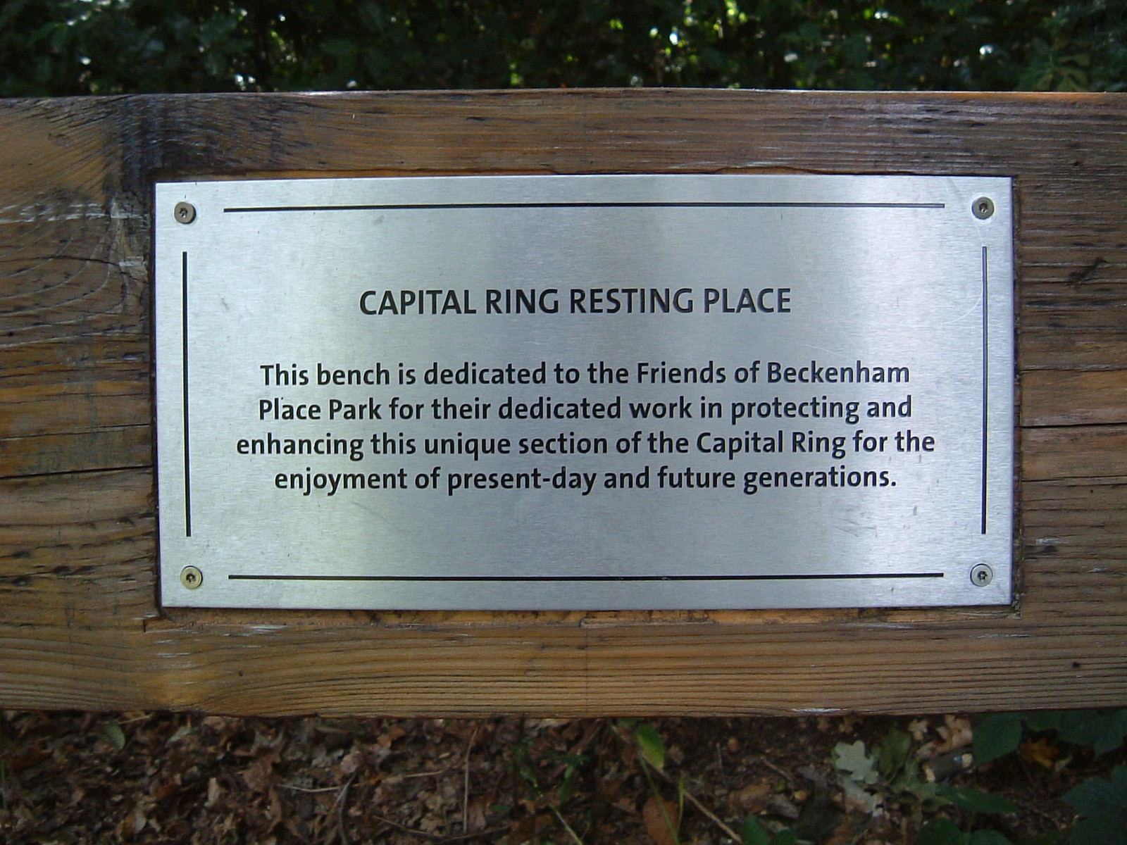 A dedication plaque on a bench in Beckenham Place Park