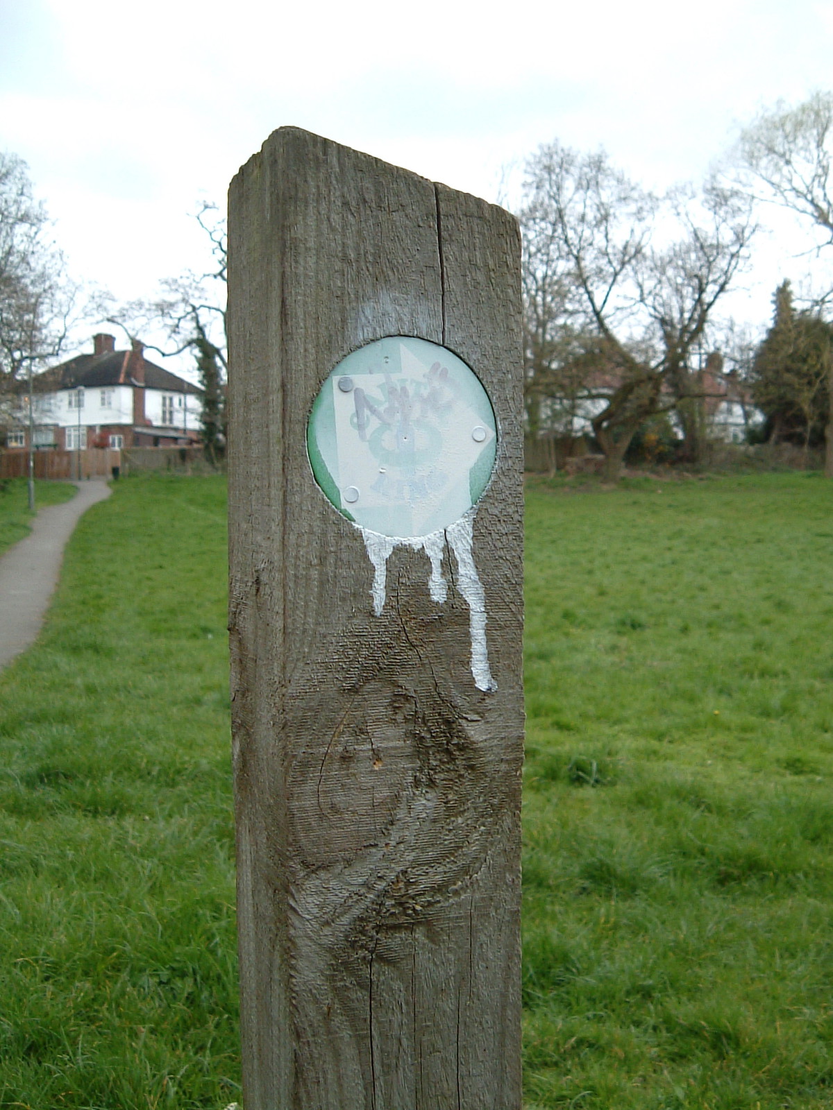 A vandalised Capital Ring signpost where Dollis Brook and Mutton Brook merge to form the River Brent