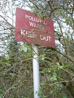 A sign along Mutton Brook that says 'Polluted Water, Keep Out'