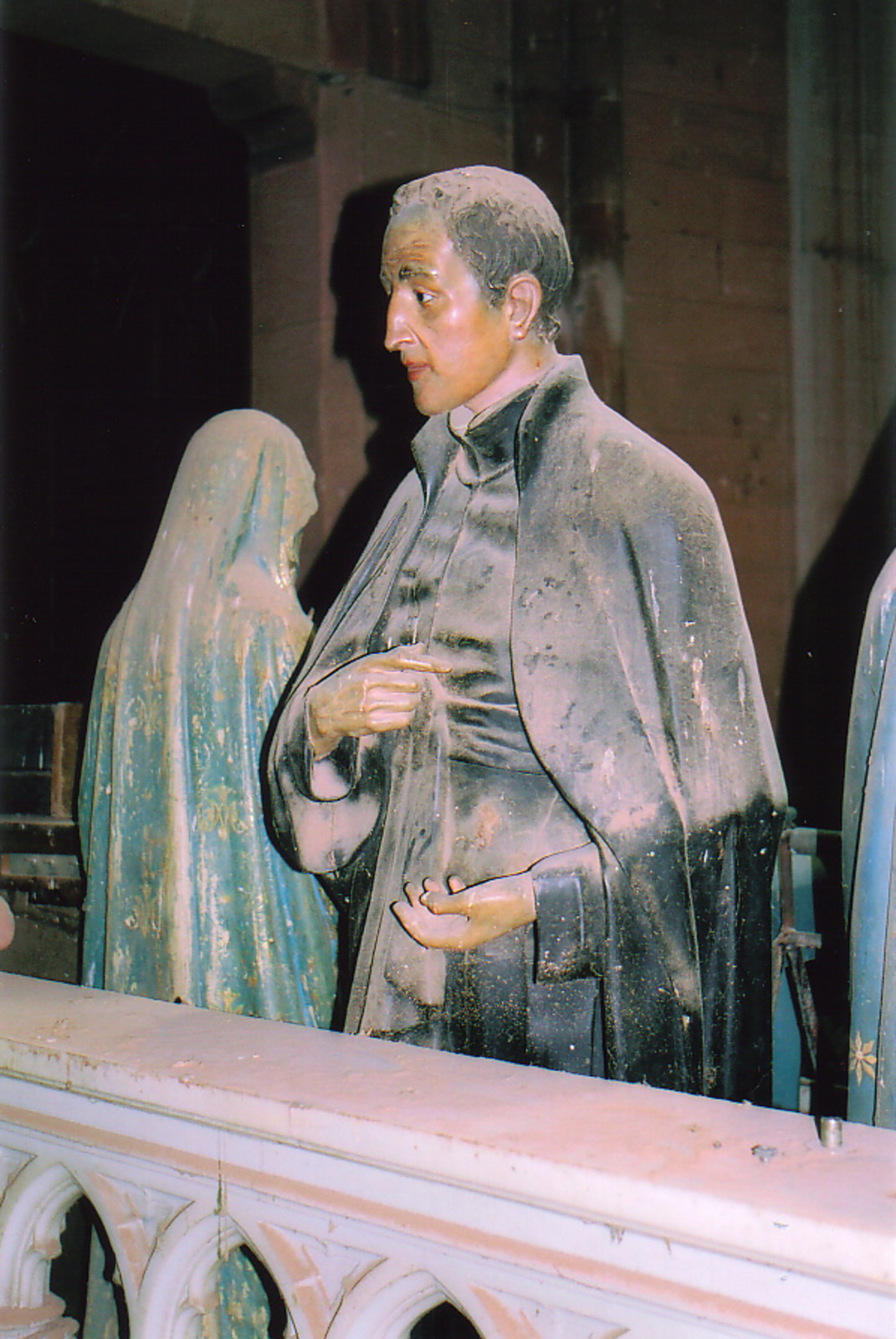 A dust-covered statue inside the church of El Sagrado Corazón de Jesus