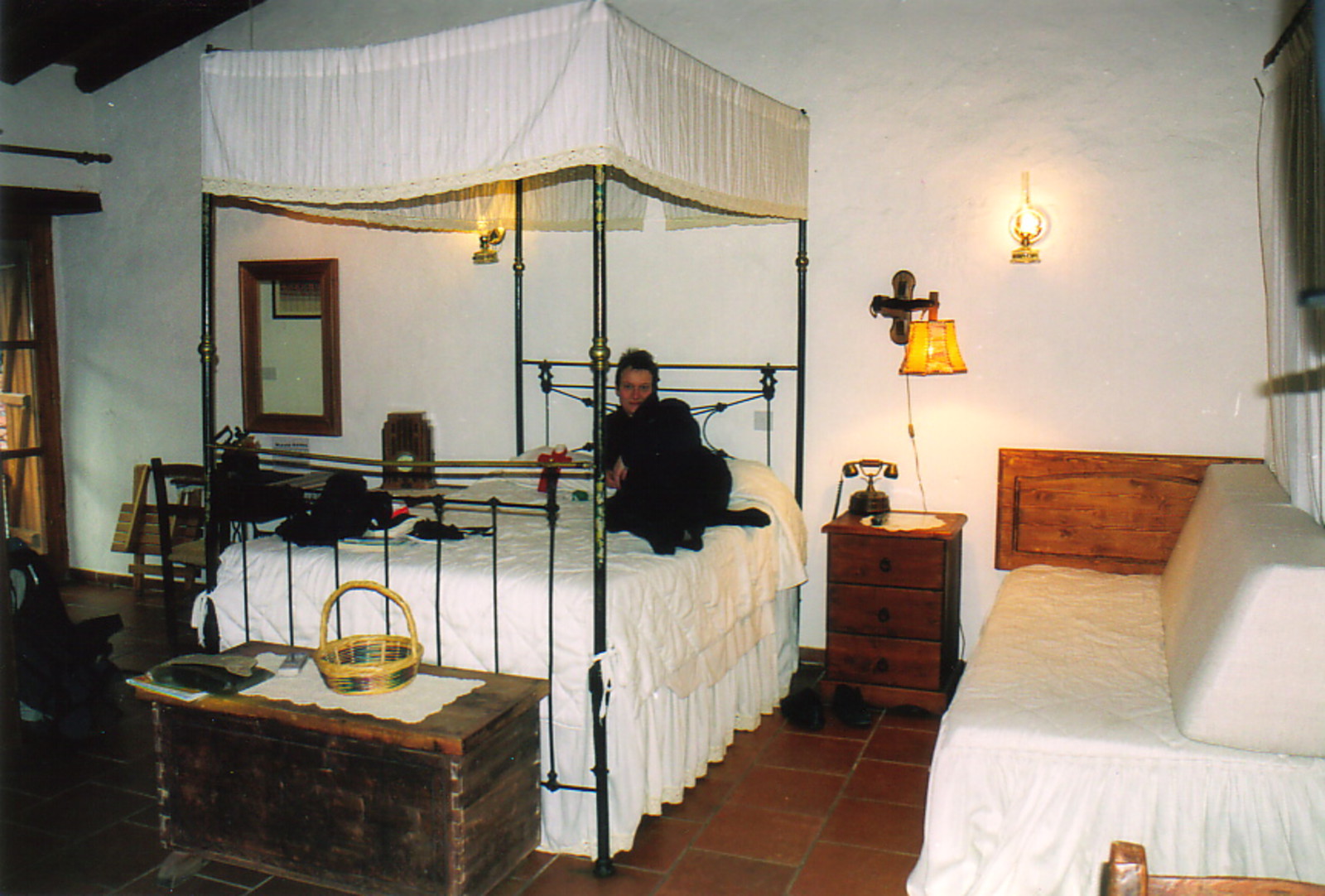 Peta on a four-poster bed in the Linos Inn