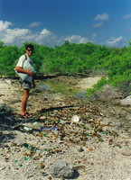 Rob standing by broken bottles on Amanu