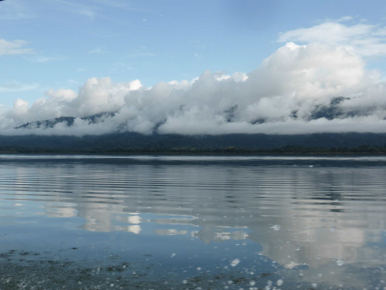 The shores of El Golfete finally starting to peek out of the cloud