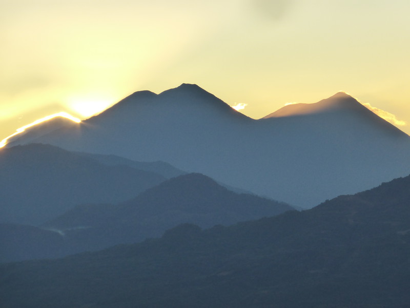 The sun rising behind Volcán Fuego (right), Volcán Agua and Actenango
