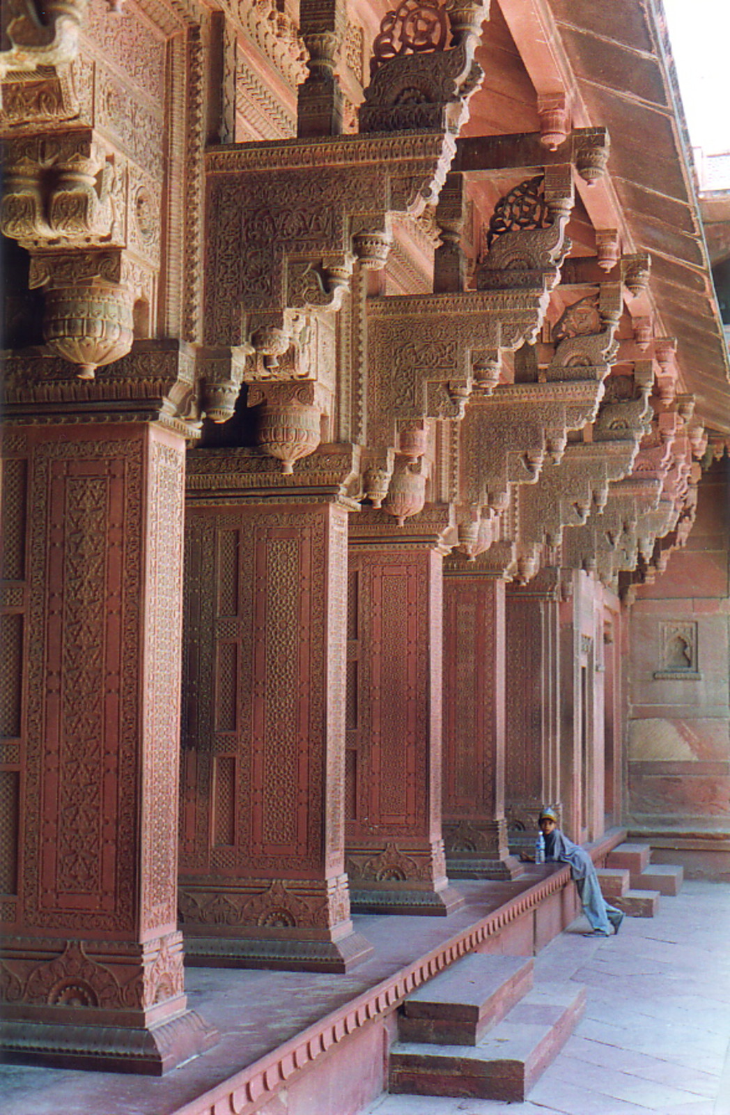 Intricate red carved pillars at Agra Fort
