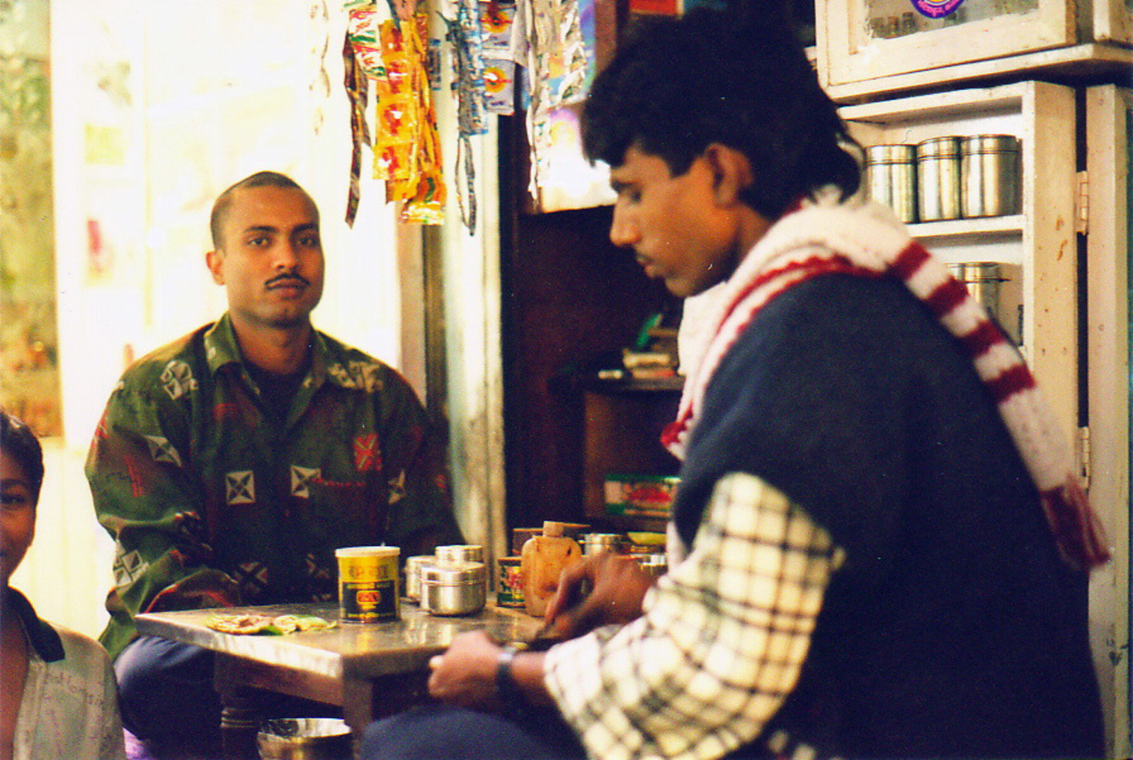 A man buying pan from the pan-wallah