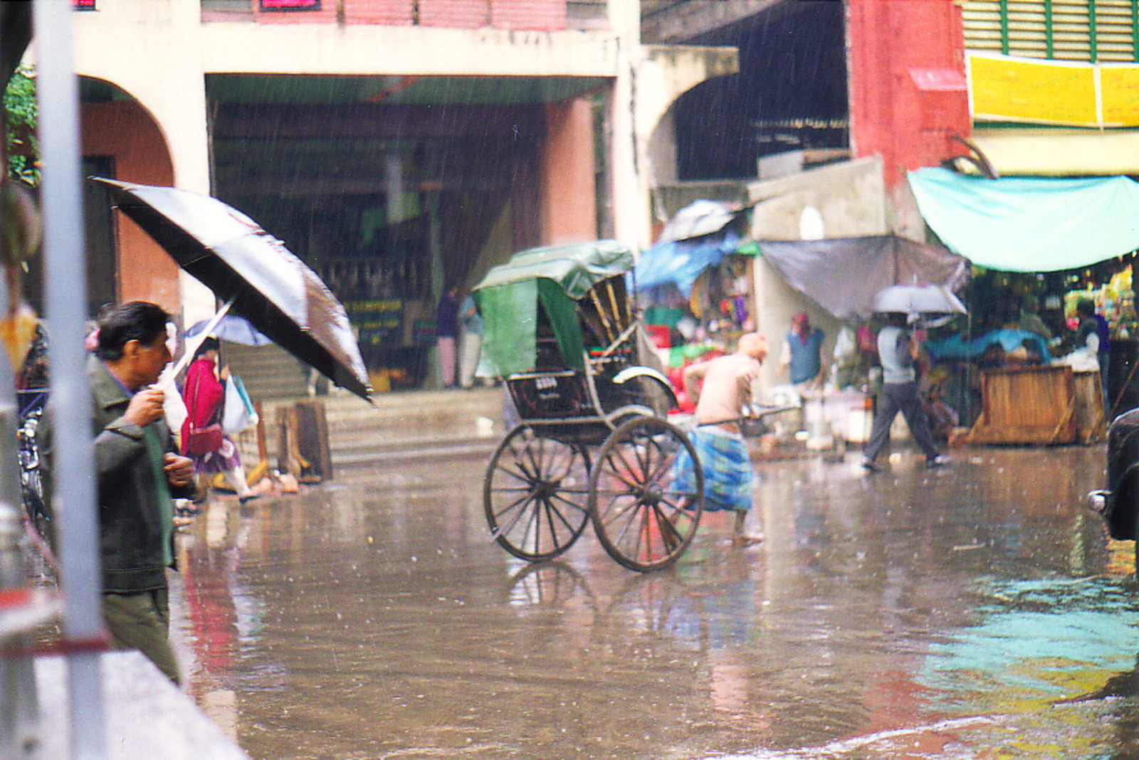 A hand-pulled rickshaw in the rain