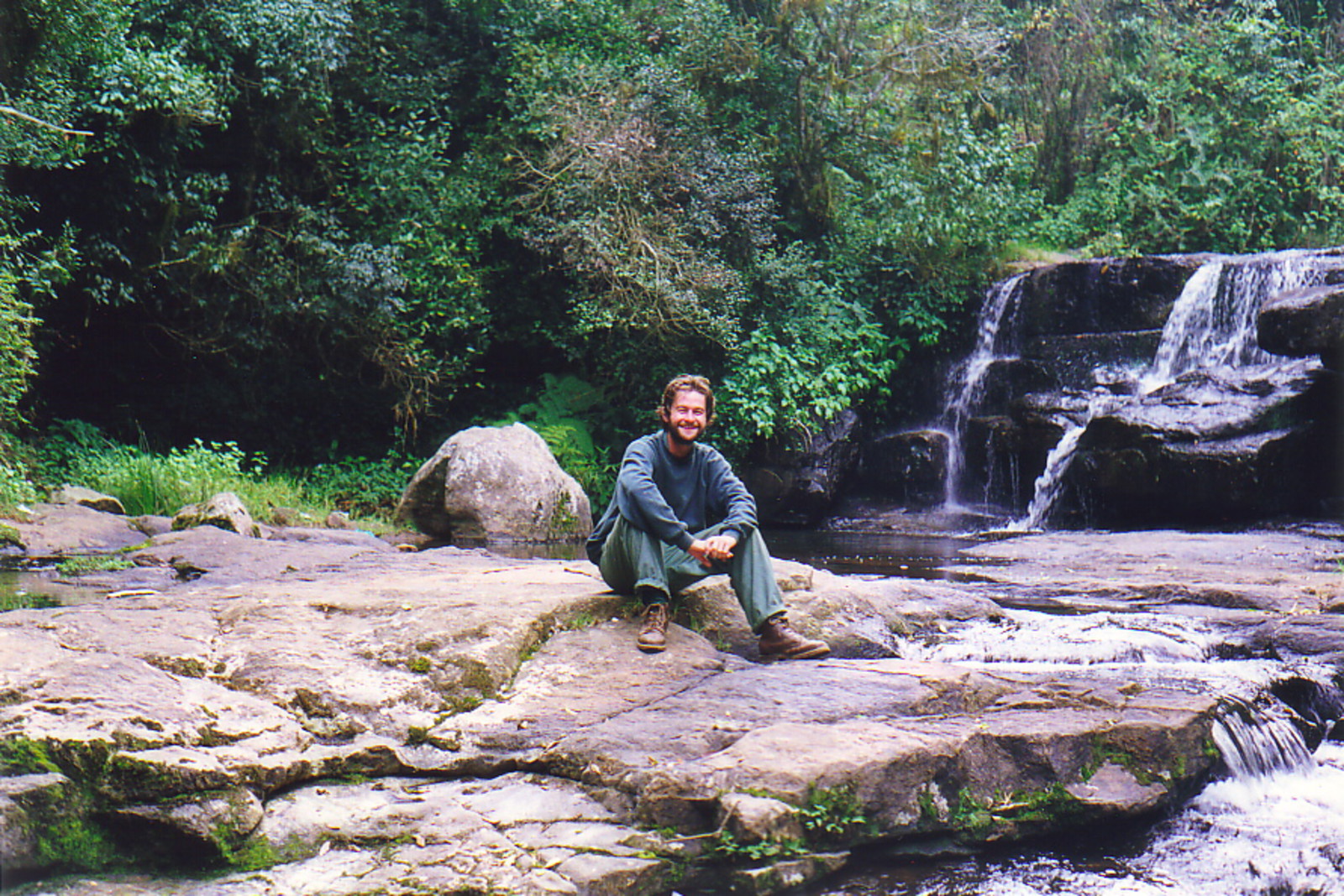 Mark sitting by a waterfall