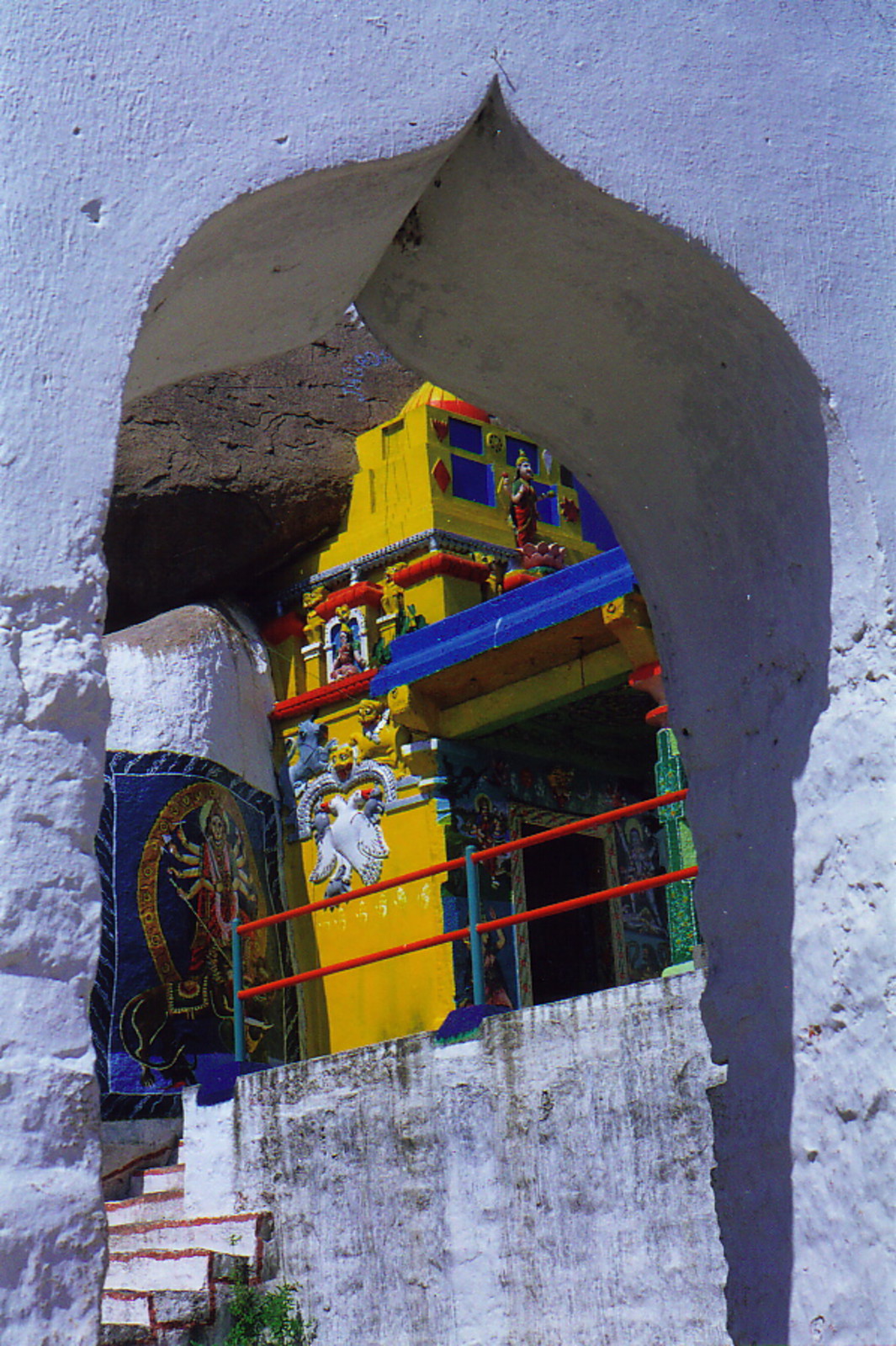 A Hindu temple glanced through an Islamic arch at Golconda