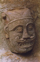 A carving of a man's grimacing face