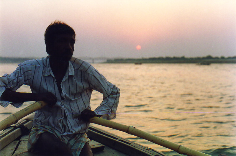 A man rowing a boat on the Ganges at dawn