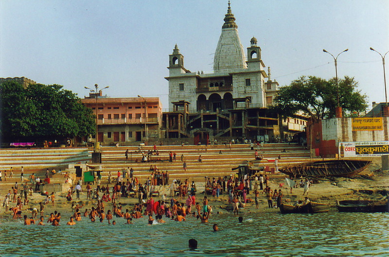 People washing themselves by a temple on the Ganges
