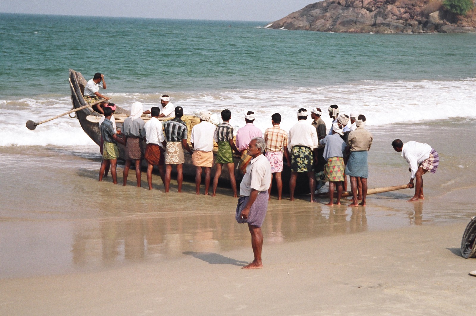 Fishermen launching their boat