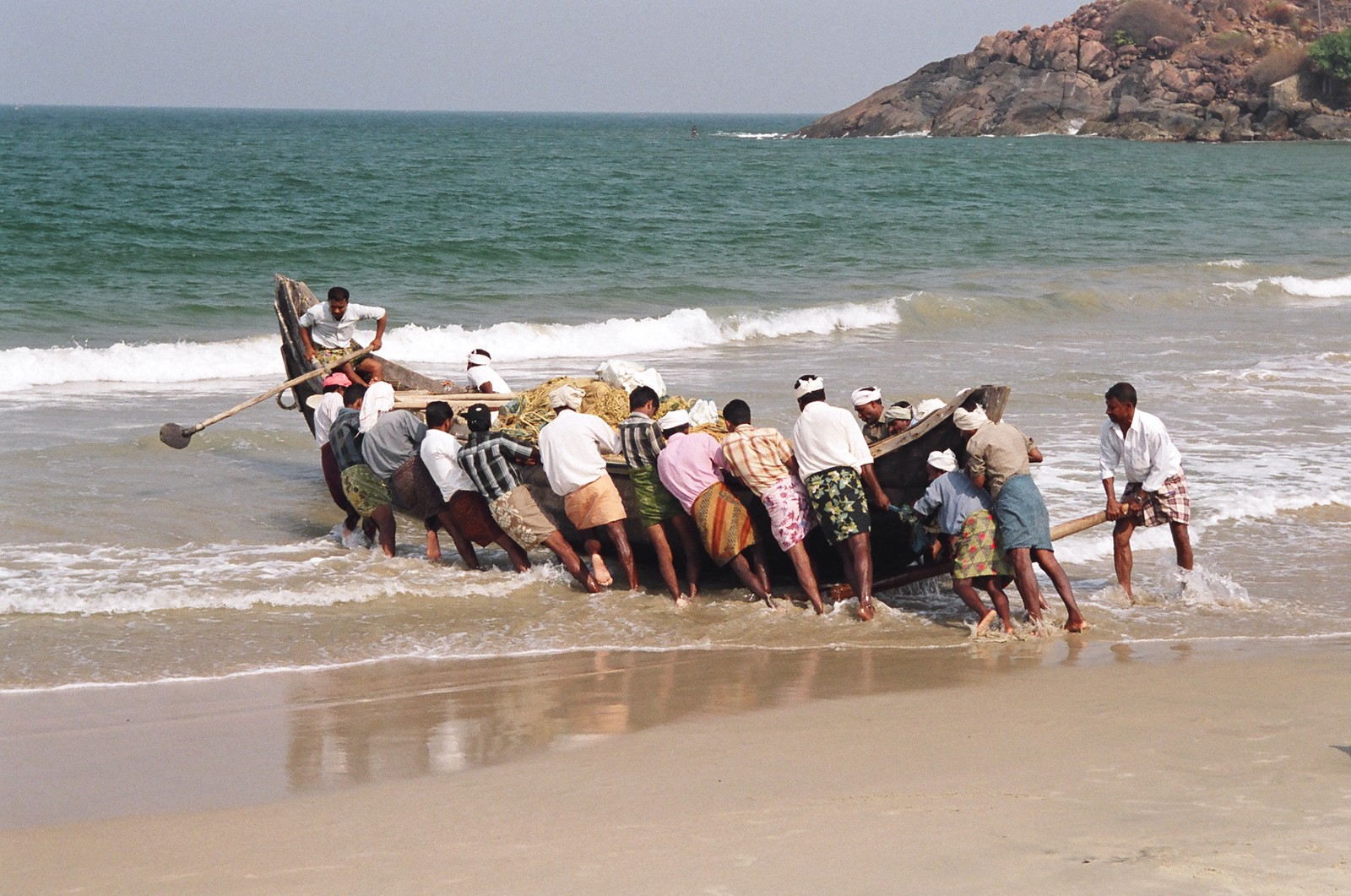 Fishermen launching their boat