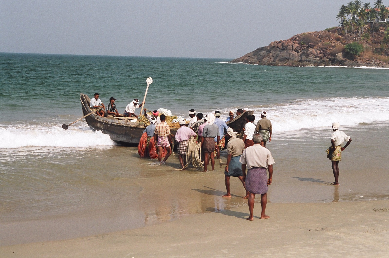Fishermen launching their boat