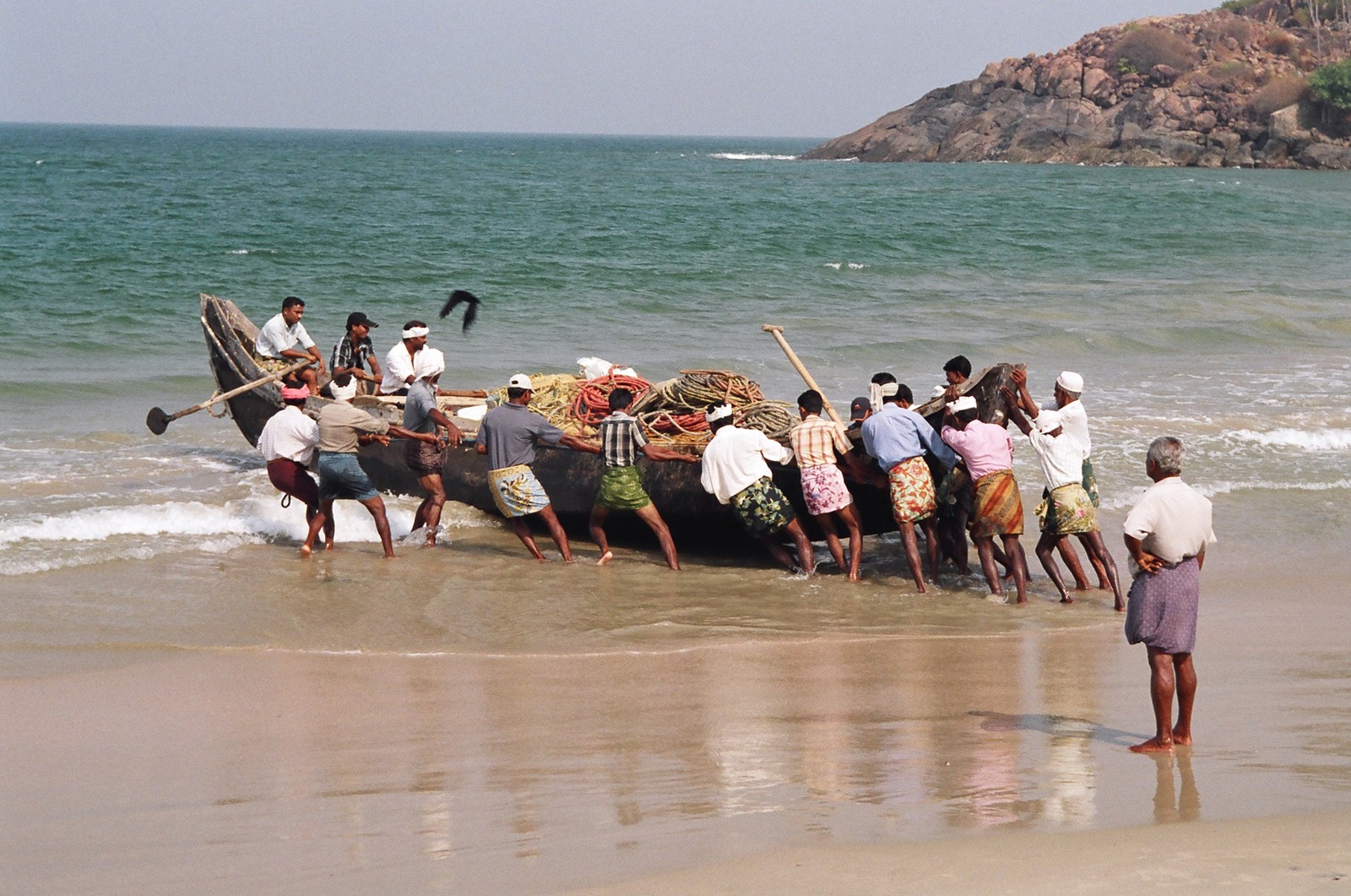 Fishermen launching their boat