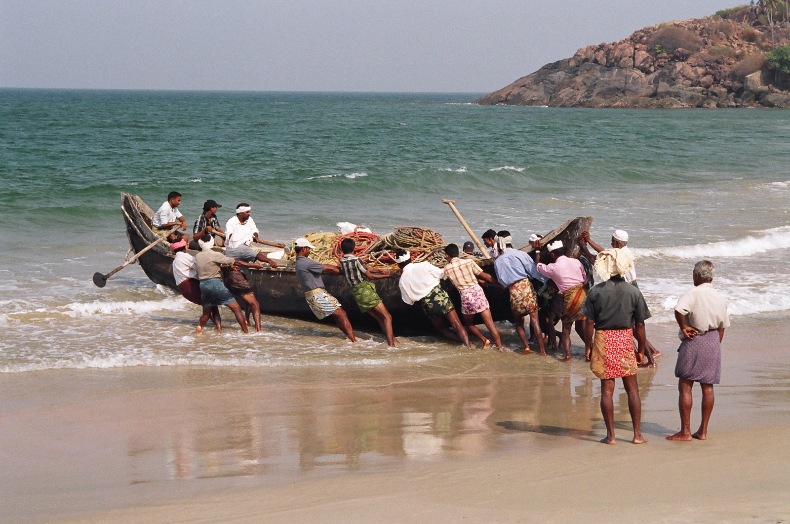 Fishermen launching their boat