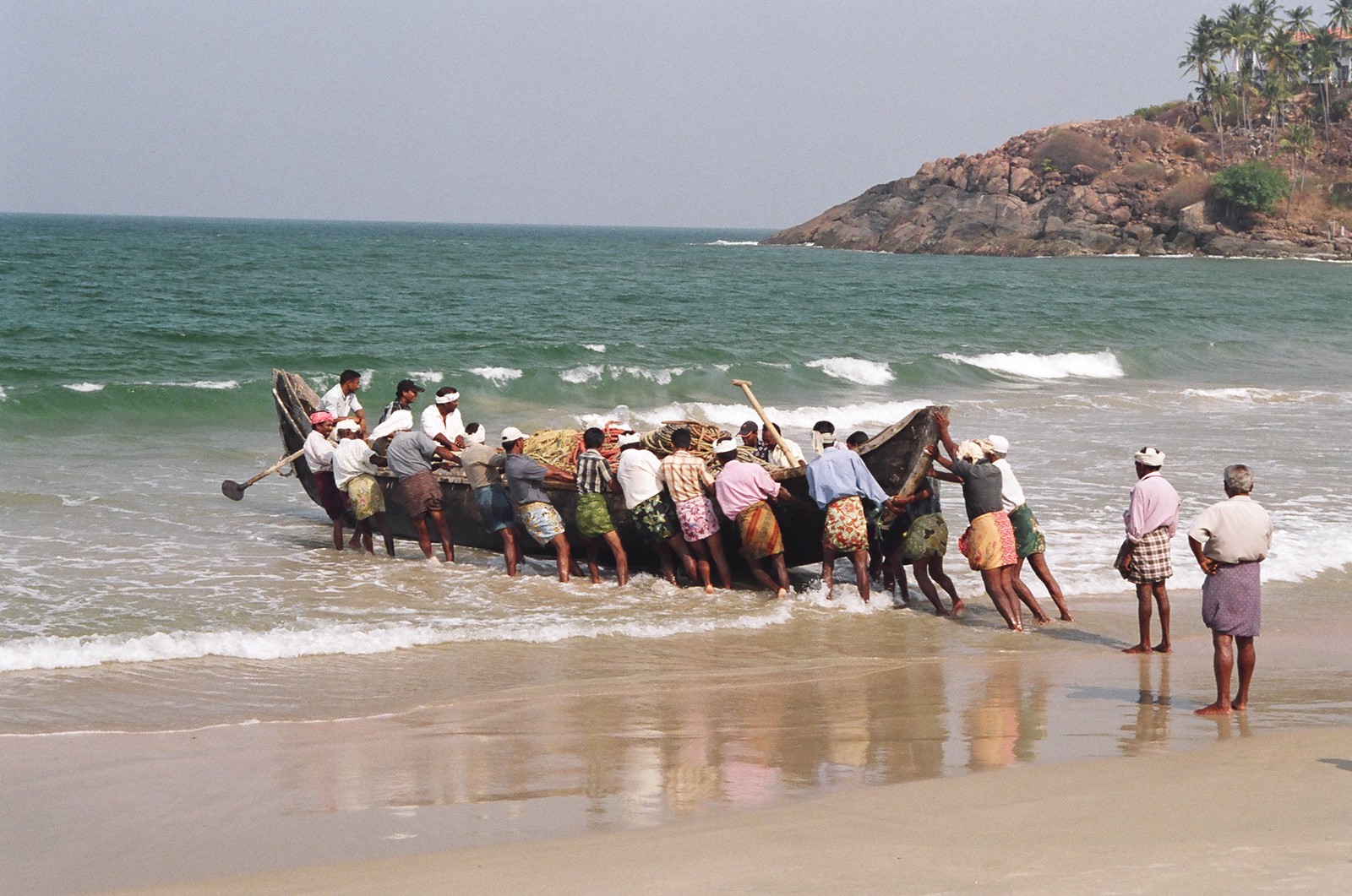 Fishermen launching their boat