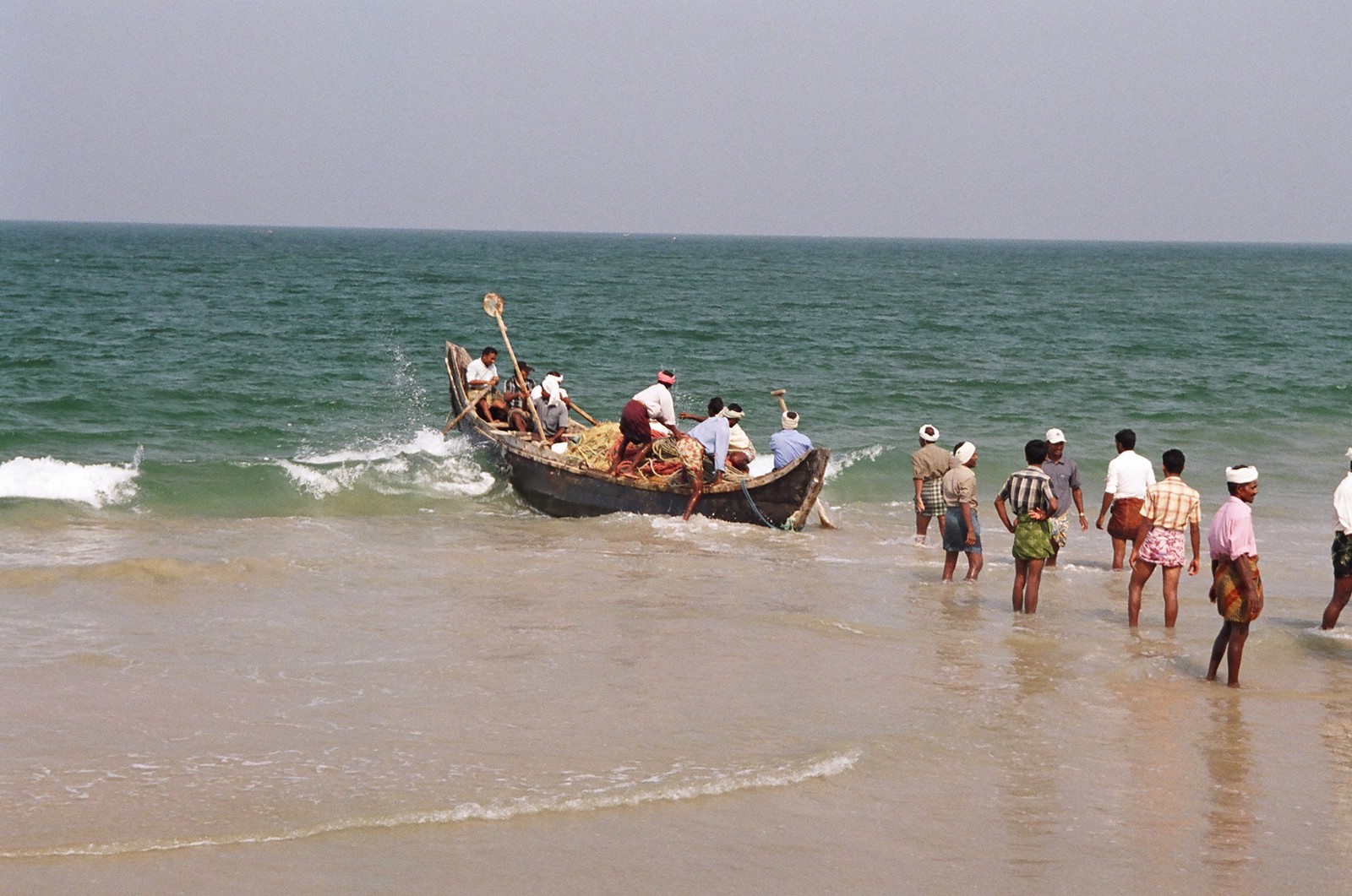 Fishermen launching their boat