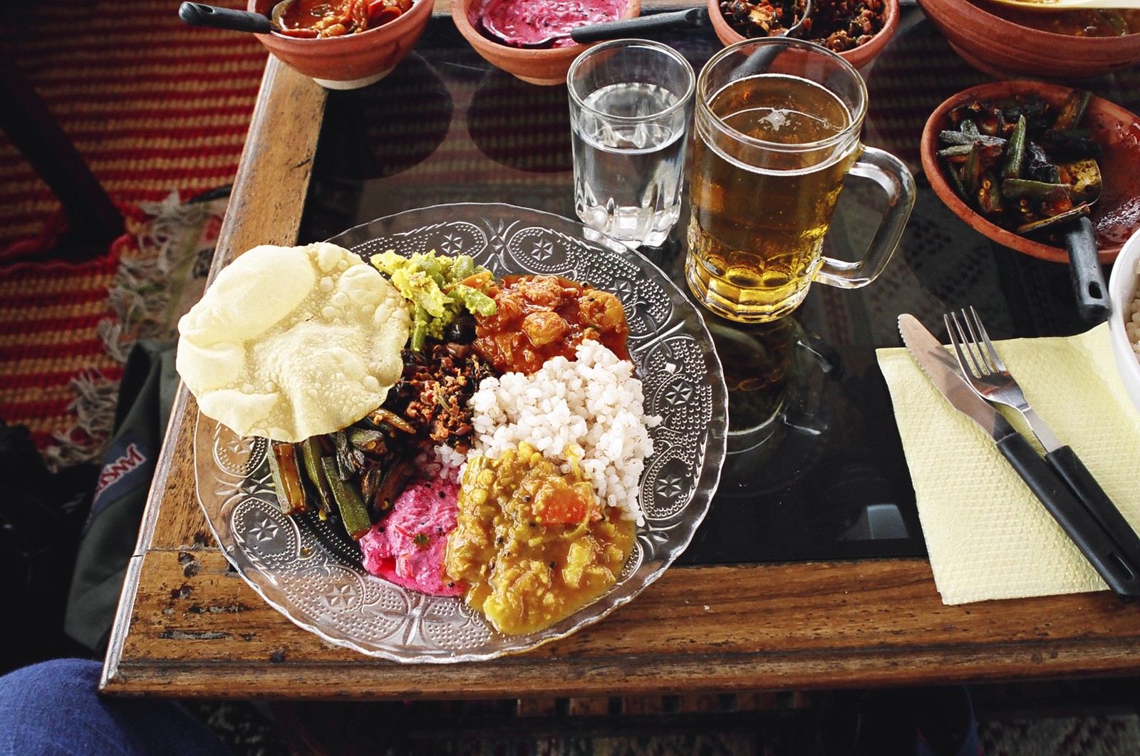 Lunch, consisting of masala prawns, beetroot yoghurt, spinach, ladyfinger, sambal, beans, rice, pappadams