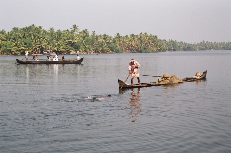 Men filling a canoe filled with sand