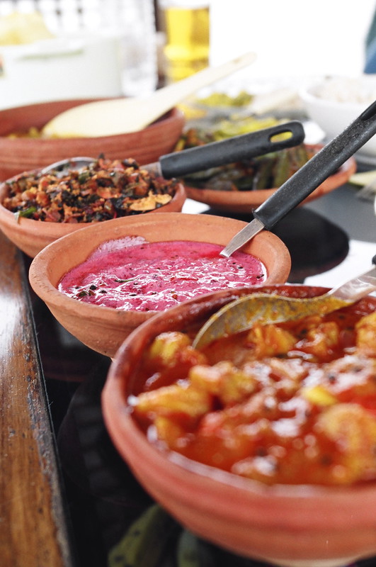 Lunch, consisting of masala prawns, beetroot yoghurt, spinach, ladyfinger, sambal, beans, rice, pappadams