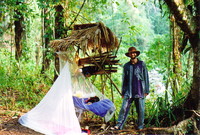 Mark standing in the jungle in some Balinese pyjamas