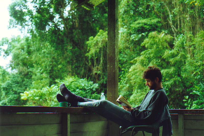 Mark reading a book on the veranda at Kuala Perkai