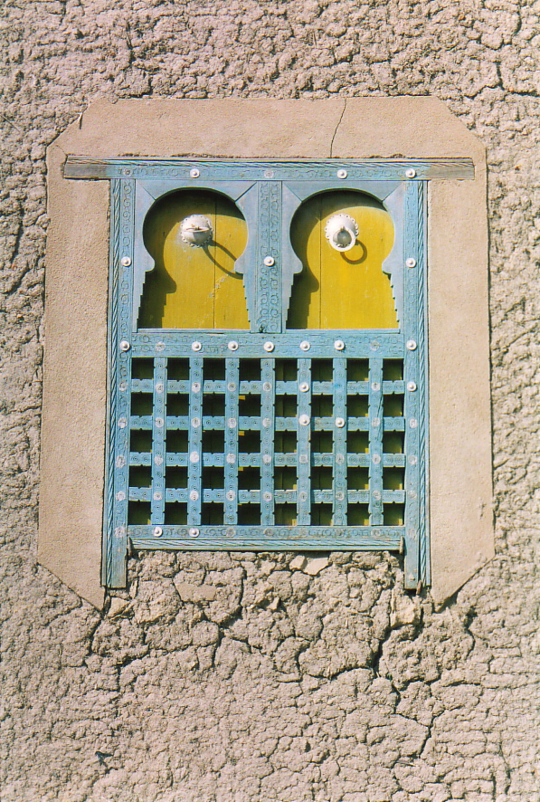 An intricate window set into a mud building in Djenné