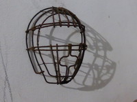 An iron head mask on the hotel wall