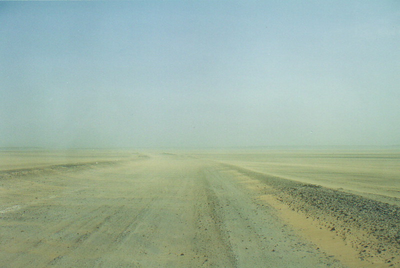 A desert road hidden by a sandstorm
