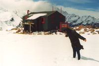 Ben leaning into the wind outside the Mueller Hut