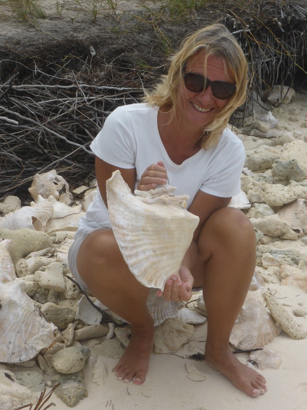 Peta holding a large conch shell