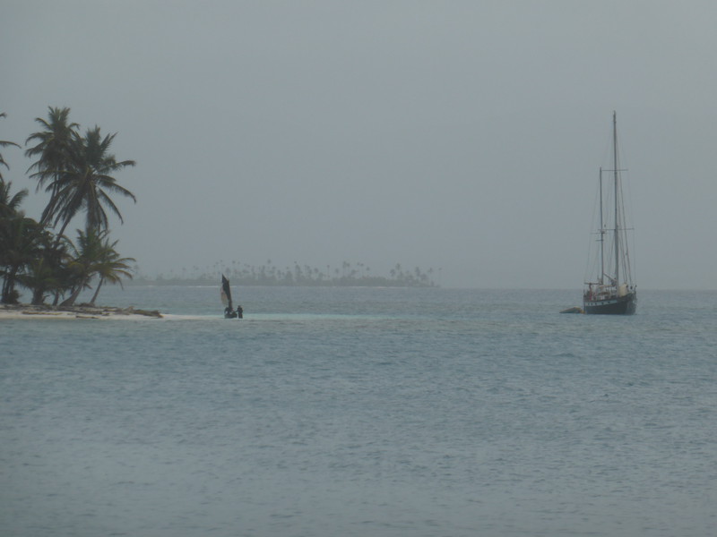 The Kuna's small boat sailing past <i>The Black Dragonfly</i>