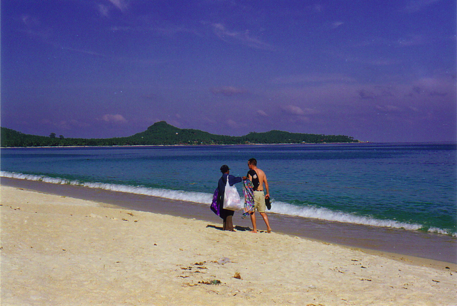 A tourist being approached by a salesman on Lamai Beach