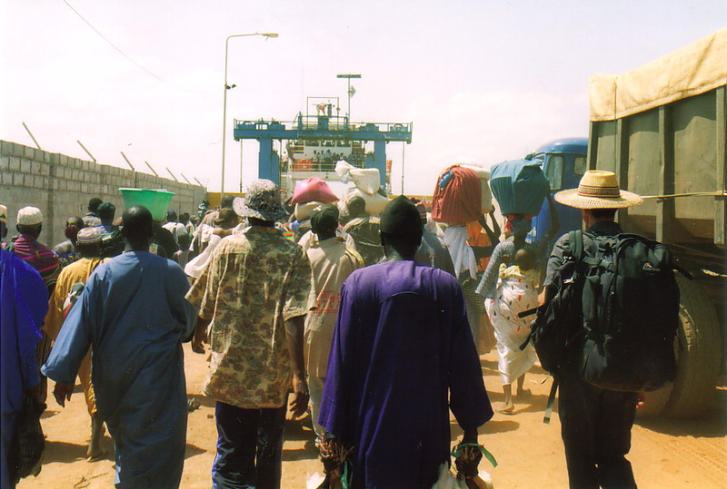 A crowd of people walking onto a ferry